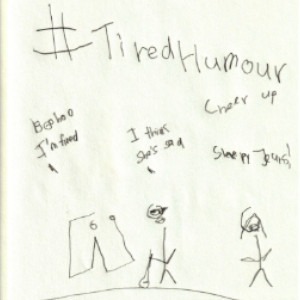 An image depicts a pair of jeans standing on the left side saying, "Boo hoo, I'm tired." Further right, a stick figure of Marc holding his white cane says, "I think she's sad." Further right, a stick figure of Jan says, "Cheer up, sleepy Jeans!" The hashtag "#TiredHumour" is written in big letters above the scene.