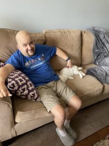 A photo of Marc petting his bunny Sir Benjamin Bunnington the 4th, after the rabbit has flopped in satisfaction.